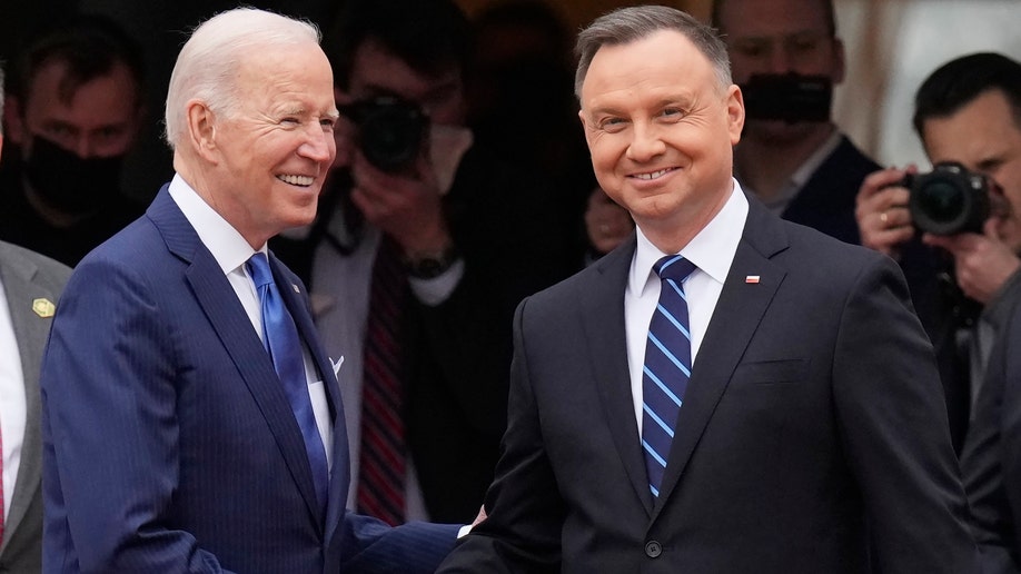 U.S. President Joe Biden, left, and Polish President Andrzej Duda shake hands during a military welcome ceremony at the Presidential Palace in Warsaw, Poland, on Saturday, March 26, 2022. (AP Photo/Czarek Sokolowski)