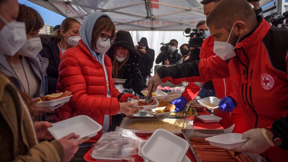 Ukrainian refugees evacuated from Lviv receive hot meals brought by Italian Red Cross volunteers, on March 22, 2022 in Rome, Italy. About 80 frail people including children, elderly and disabled were evacuated from Lutsk, Kharhiv and Kiev by the Italian Red Cross in collaboration with the Civil Protection Department. (Photo by Antonio Masiello/Getty Images)