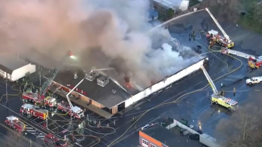 A massive fire tore through a Philadelphia-area bowling alley early Wednesday and destroyed the entire structure.