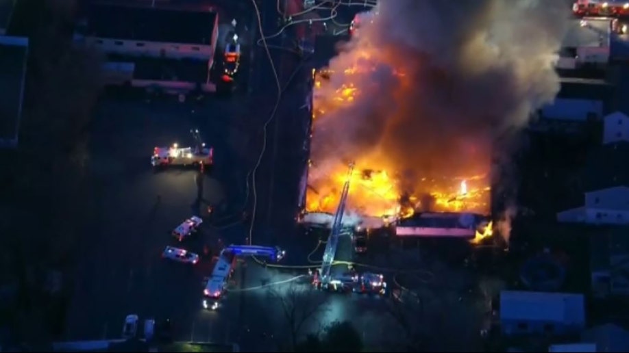 A massive fire tore through a Philadelphia-area bowling alley early Wednesday and destroyed the entire structure.