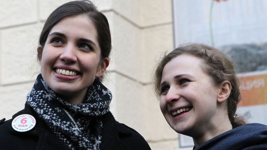 Tolokonnikova and Alekhina stand outside of Zamoskvoretsky District Court, Moscow, Russia