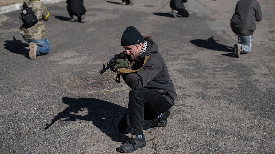 Civilians practice moving in groups at a military training exercise conducted by the Prosvita society in Ivano-Frankivsk, Ukraine, on Friday, March 11, 2022. (Alexey Furman/Bloomberg via Getty Images)