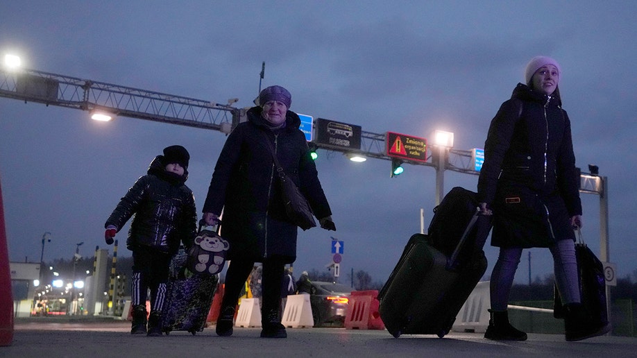 Ukrainian refugees arrive at the border crossing in Medyka