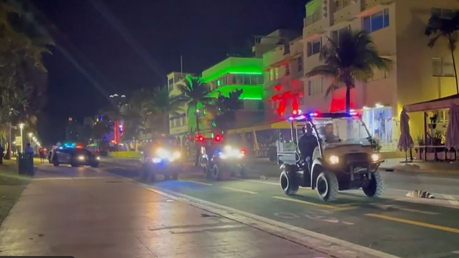 Miami Beach police ask visitors to clear the streets at midnight on night 1 of the city's spring break curfew in Miami Beach, Florida on March 24, 2022.