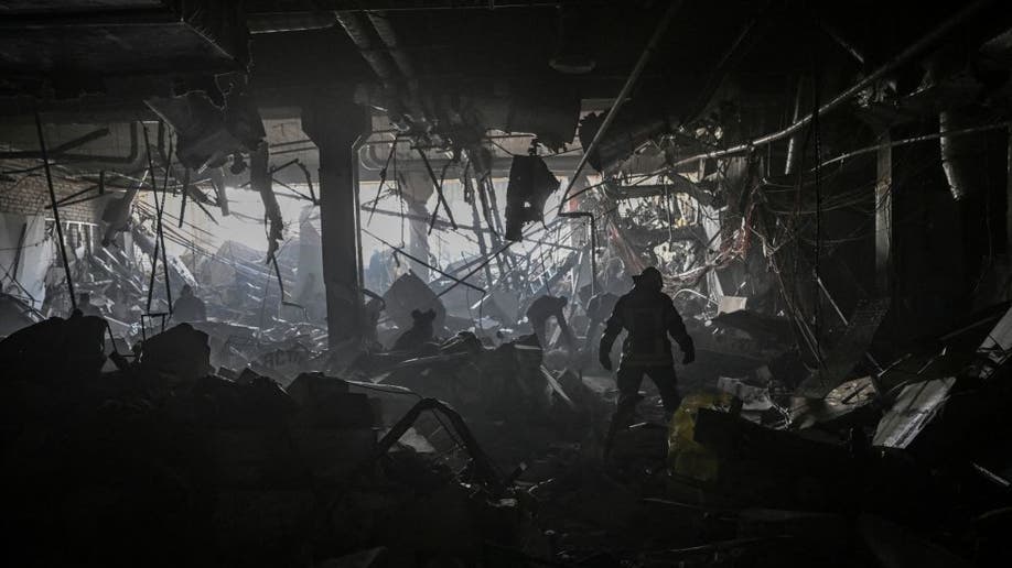 Ukraine firefighters picking through debris