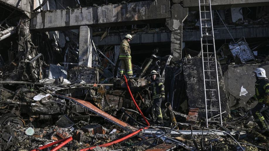firefighters pick through debris after shopping center damaged near Kyiv