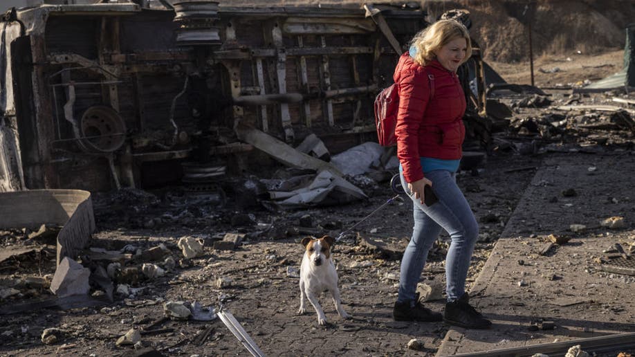 A woman walks her dog in Kyiv, Ukraine