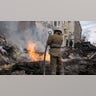 Firefighters extinguish an apartment house after a Russian rocket attack in Kharkiv, Ukraine's second-largest city, Ukraine, Monday, March 14, 2022.