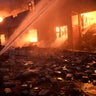 Ukrainian firefighters extinguish a blaze at a warehouse after a bombing on the outskirts of Kyiv, Ukraine, Thursday, March 17, 2022.