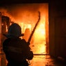 Ukrainian firefighters extinguish a blaze at a warehouse after a bombing in Kyiv, Ukraine, Thursday, March 17, 2022.