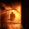 Ukrainian firefighters extinguish a blaze at a warehouse after a bombing in Kyiv, Ukraine, Thursday, March 17, 2022.