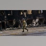 A Ukrainian soldier walks past a building that was destroyed in the midst of battle with the Russians, on the outskirts of Irpin, Ukraine, Tuesday, March 1, 2022.