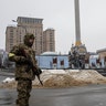 Members of Ukraine's Territorial Defense stand guard next to sand berms at Independence Square in Kyiv, Ukraine, on Wednesday, March 2, 2022.