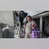 An injured pregnant woman walks downstairs in the damaged by shelling maternity hospital in Mariupol, Ukraine, Wednesday, March 9, 2022. A Russian attack has severely damaged a maternity hospital in the besieged port city of Mariupol, Ukrainian officials say.