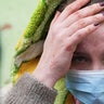 A woman walks outside the damaged by shelling maternity hospital in Mariupol, Ukraine, Wednesday, March 9, 2022. A Russian attack has severely damaged a maternity hospital in the besieged port city of Mariupol, Ukrainian officials say.