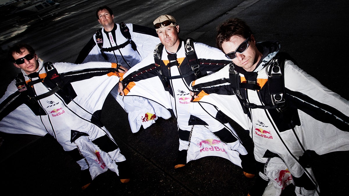 SEATTLE, WA - JUNE 10, 2010: Red Bull Air Force skydivers Luke Aikens, Jon Devore, Andy Farrington and Miles Daisher prepare before taking off to swoop over downtown Seattle in wing suits on June 10, 2010 in Seattle, Washington. (Photo by Christian Pondella/Getty Images)