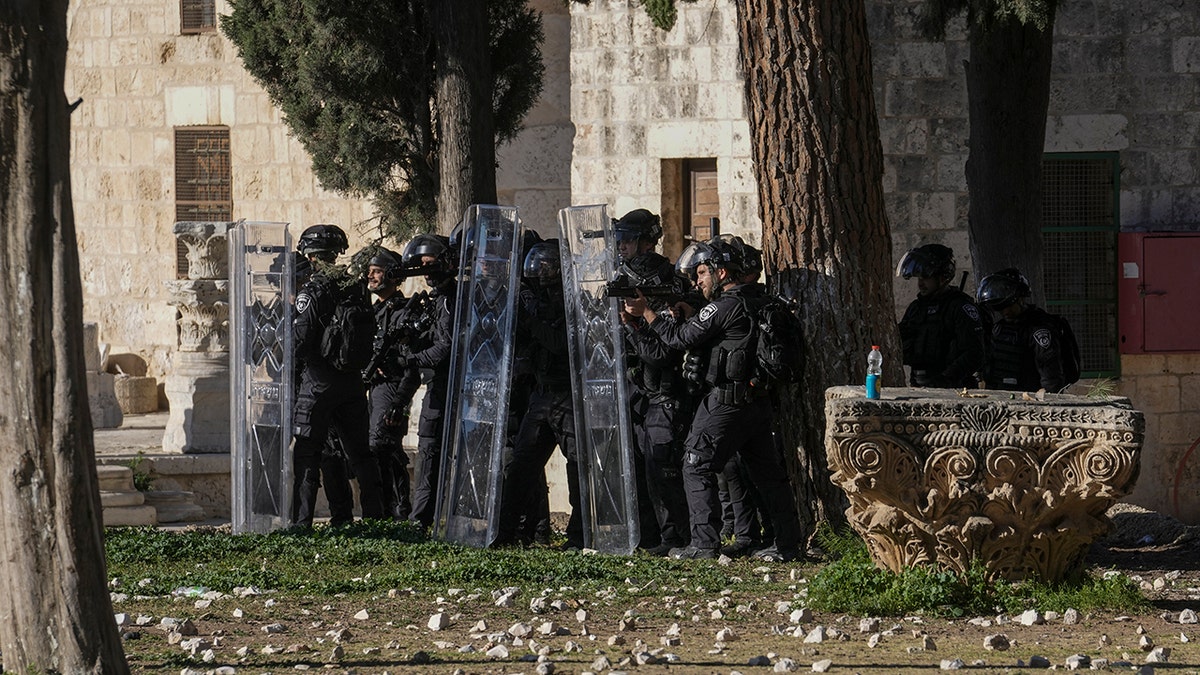 Israeli security forces take position during clashes with Palestinians demonstrators at the Al Aqsa Mosque compound in Jerusalem's Old City, Friday, April 15, 2022. 