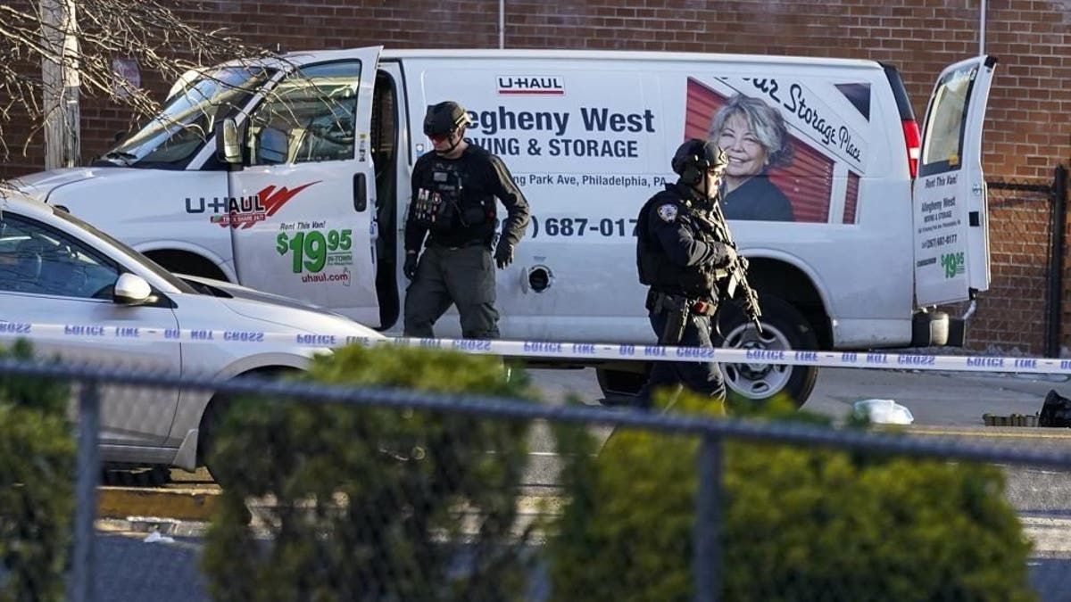 Bomb squad personnel search a moving truck during an ongoing investigation in the Brooklyn borough of New York, Tuesday, April 12, 2022.