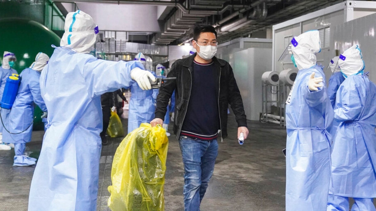 COVID-19 patients leave a makeshift hospital in Shanghai