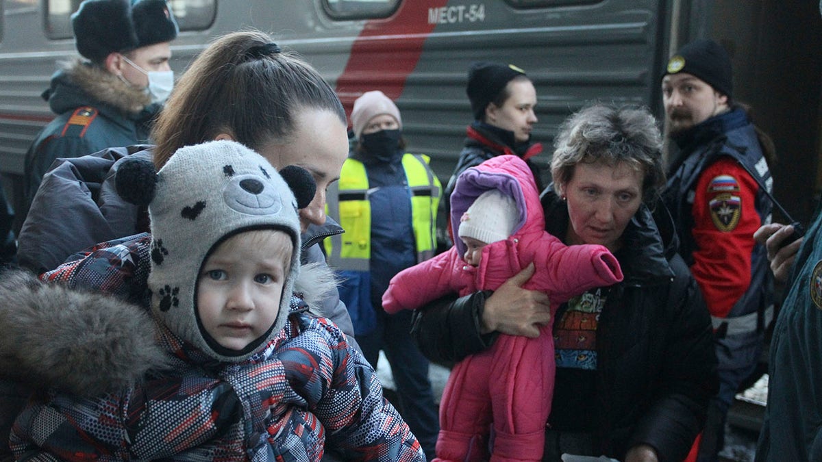 People from Mariupol and surroundings in eastern Ukraine, leave a train to be taken to temporary residences in Nizhny Novgorod region, at the railway station in Nizhny Novgorod, Russia, Thursday, April 7, 2022. About 500 refugees from Mariupol arrived Thursday in Nizhny Novgorod by a special train from eastern Ukraine. 