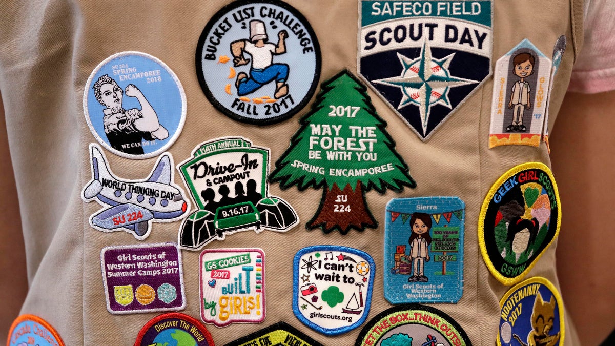 Patches cover the back of a Girl Scout's vest at a demonstration of some of their activities in Seattle, June 18, 2018.