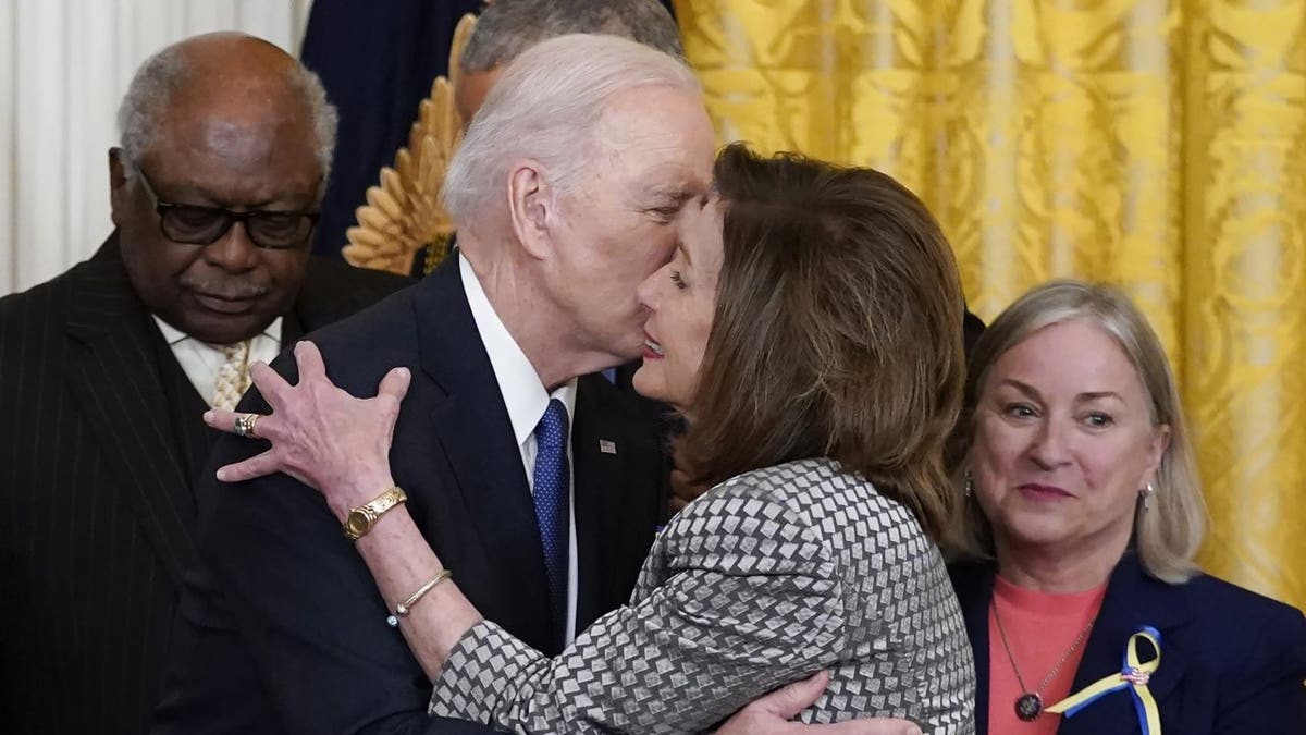 Speaker Nancy Pelosi kisses President Biden