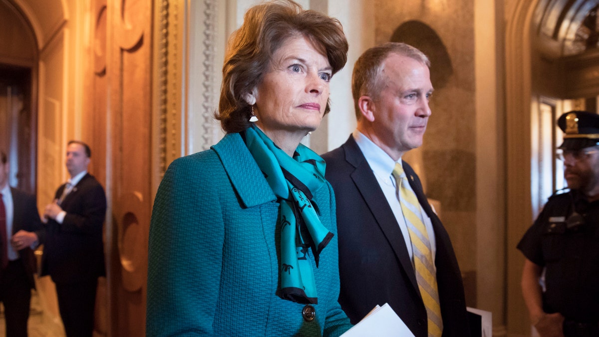 FILE - Sen. Lisa Murkowski, R-Alaska, and Sen. Dan Sullivan, R-Alaska, leave the chamber after a vote on Capitol Hill in Washington on May 10, 2017.