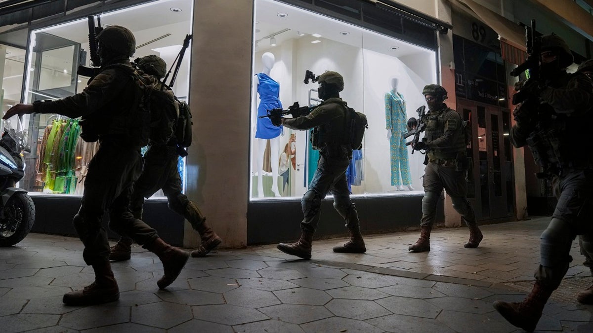 Israeli forces search for assailants following a shooting in Tel Aviv