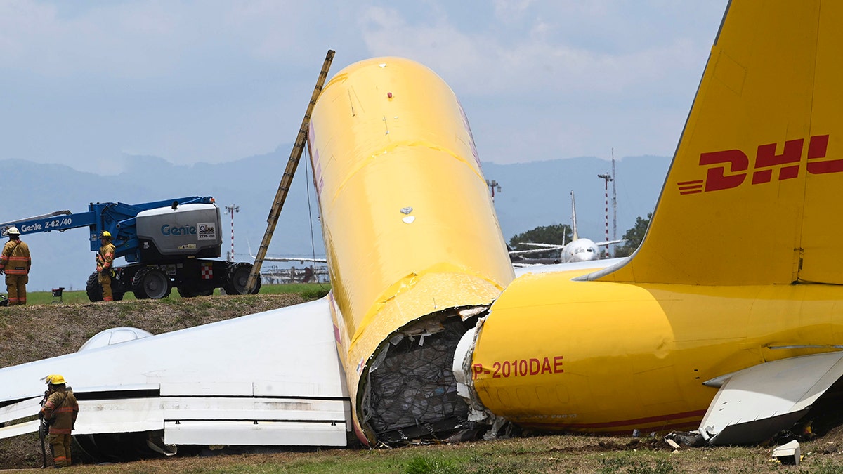 A cargo jet that spun off lays broken on the runway of the Juan Santamaria International Airport in Alajuela, Costa Rica, Thursday, April 7, 2022.