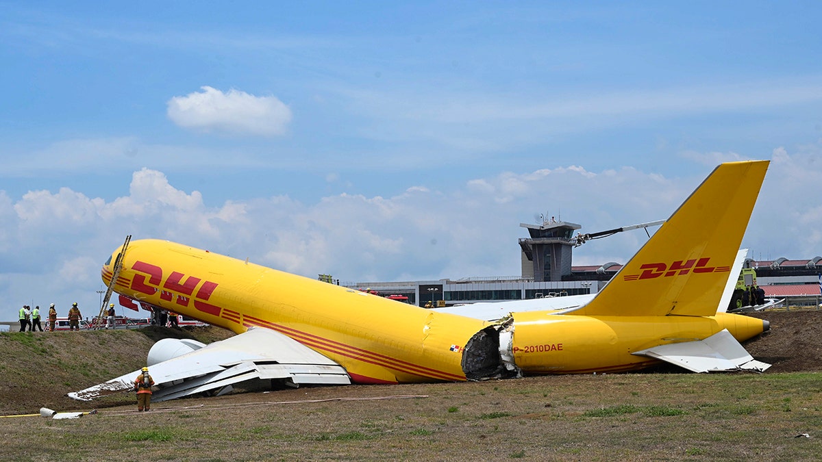 A cargo jet that spun off lays broken on the runway of the Juan Santamaria International Airport in Alajuela, Costa Rica, Thursday, April 7, 2022. According to the fire department, both the pilot and the co-pilot are reported in good health, and accident caused the total closure of the air terminal.