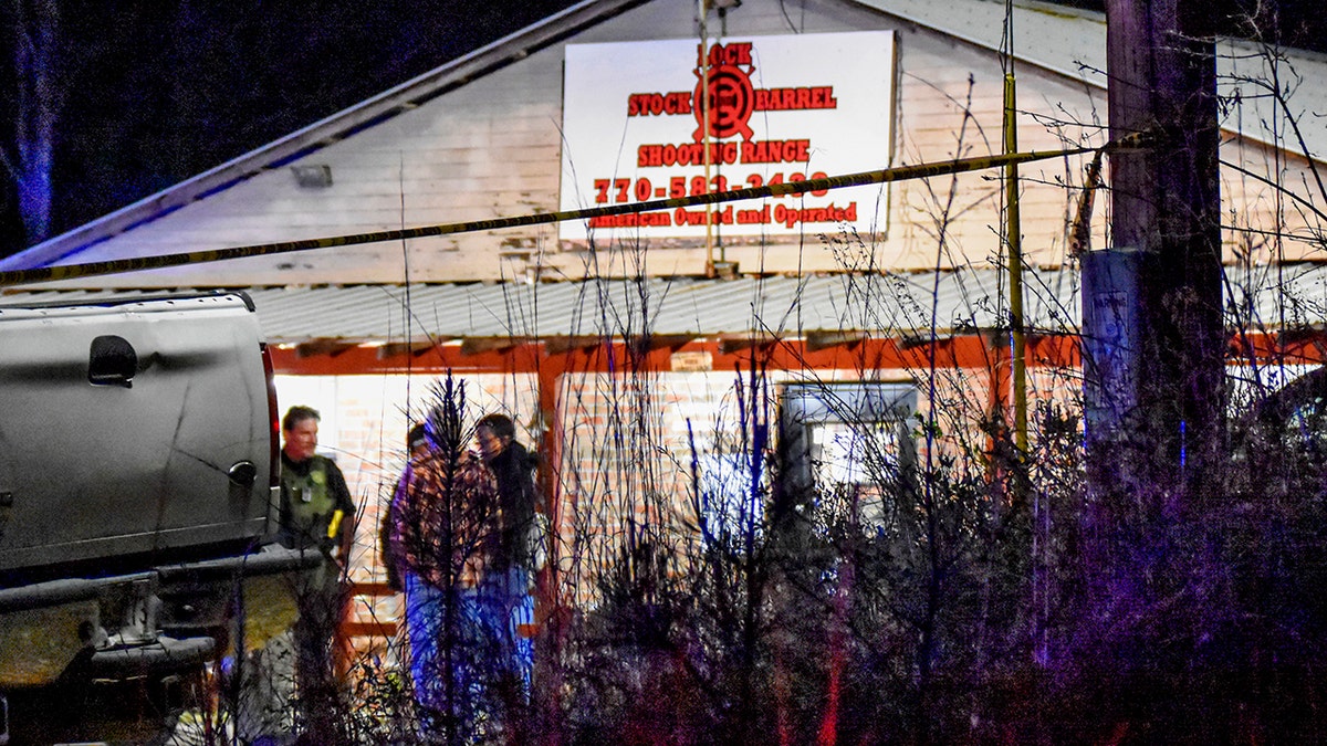 Law enforcement agents investigate the scene of a fatal robbery at Lock Stock &amp;amp; Barrel Shooting Range late Friday, April 8, 2022 in Coweta County, Ga., about 50 miles southwest of Atlanta. Authorities say a couple and their grandson are dead after an armed robbery at the gun range. The Grantville Police Department said via Facebook that the robbery occurred Friday evening. (Clay Neely/The Newnan Times-Herald via AP)