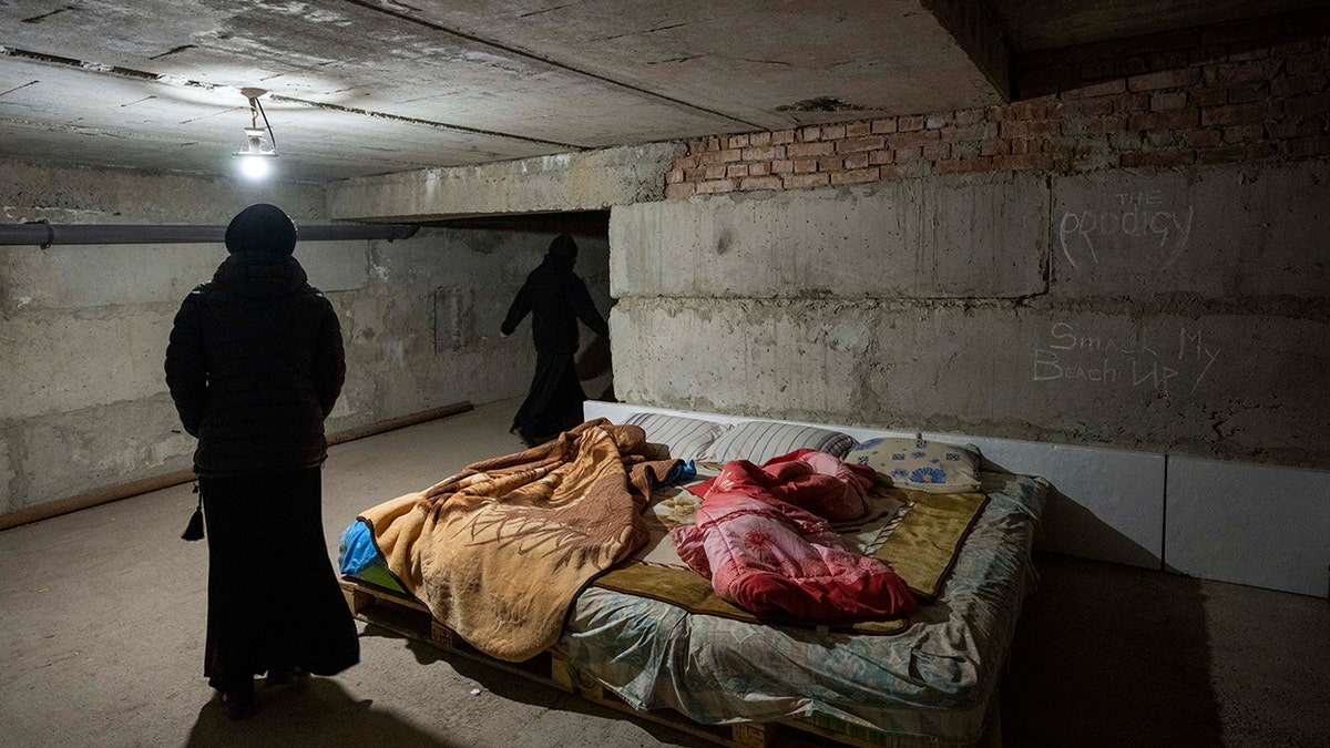 Nuns walk in the basement they have prepared to take shelter when air raids go off, at the Hoshiv Women Monastery, where nuns have been taking in internally displaced people fleeing the war, in Ivano-Frankivsk region, western Ukraine, Wednesday, April 6, 2022.