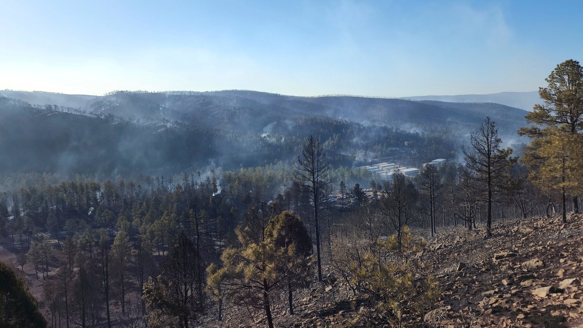 Smoke rises along a hillside in the Village of Ruidoso, N.M., on Wednesday, April 13, 2022.