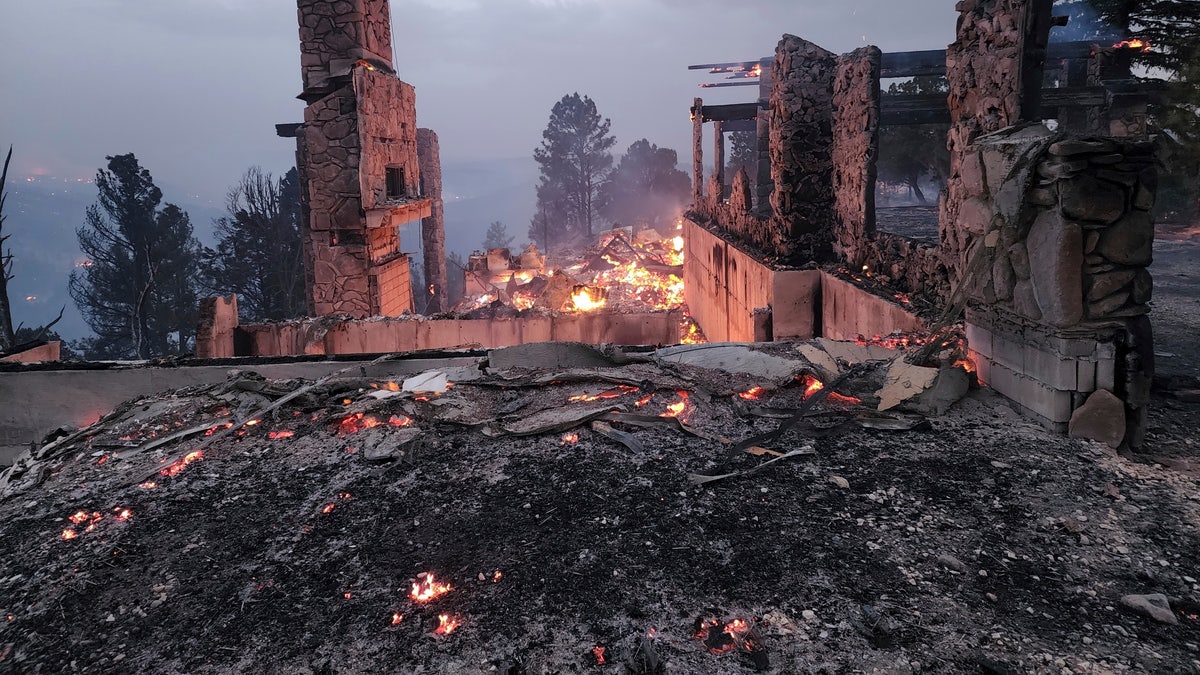 The remains of a home left after a wildfire spread through the Village of Ruidoso, New Mexico, on Wednesday, April 13, 2022.
