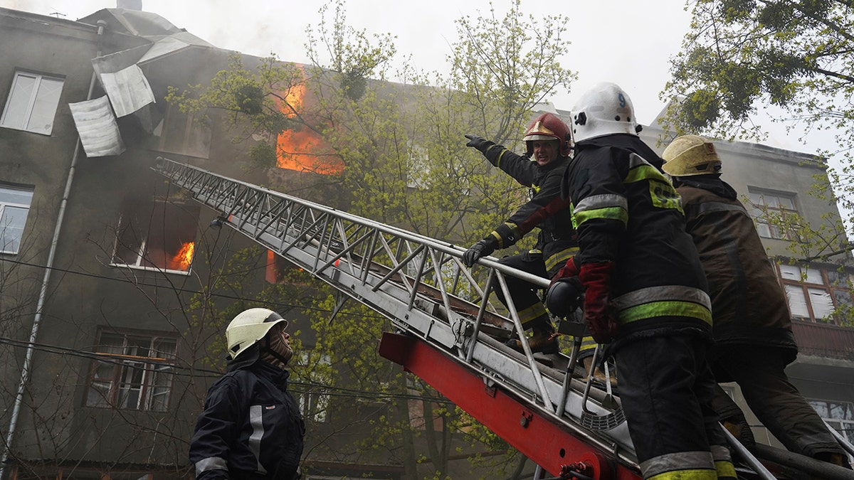 Firefighters work to extinguish fire at an apartments building after a Russian attack in Kharkiv, Ukraine, Sunday, April 17, 2022. (AP Photo/Andrew Marienko)