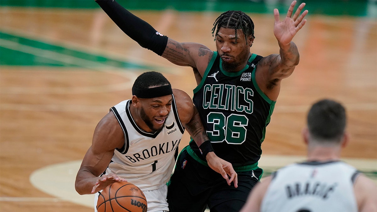 Brooklyn Nets forward Bruce Brown (1) drives with the ball as Boston Celtics guard Marcus Smart (36) defends in the second half of Game 1 of an NBA basketball first-round Eastern Conference playoff series, Sunday, April 17, 2022, in Boston. The Celtics won 115-114. 