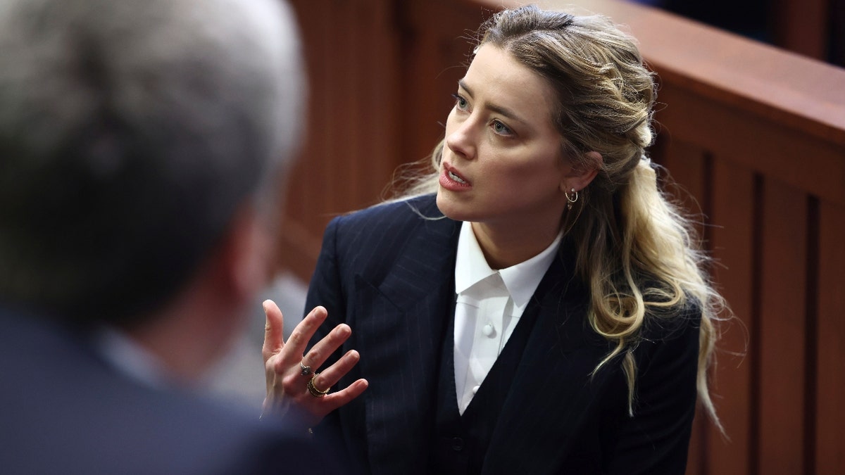 Actor Amber Heard appears in the courtroom at the Fairfax County Circuit Court in Fairfax, Va., Thursday, April 21, 2022. Actor Johnny Depp sued his ex-wife Amber Heard for libel in Fairfax County Circuit Court after she wrote an op-ed piece in The Washington Post in 2018 referring to herself as a "public figure representing domestic abuse."