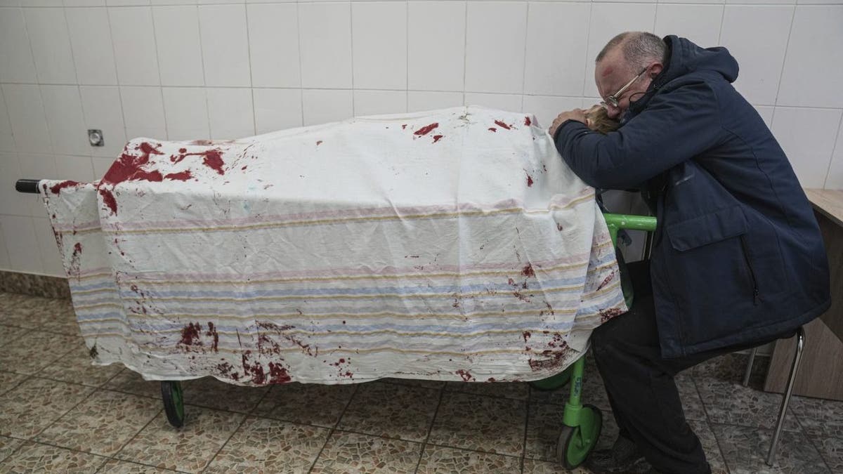 Serhii, father of teenager Iliya, cries on his son's lifeless body lying on a stretcher at a maternity hospital converted into a medical ward in Mariupol, Ukraine, March 2, 2022. A bipartisan group of U.S. lawmakers is calling on the Biden administration to establish field hospitals near Ukraine's border and ramp up medical support for what's expected to be a months-long war of attrition waged by Russia