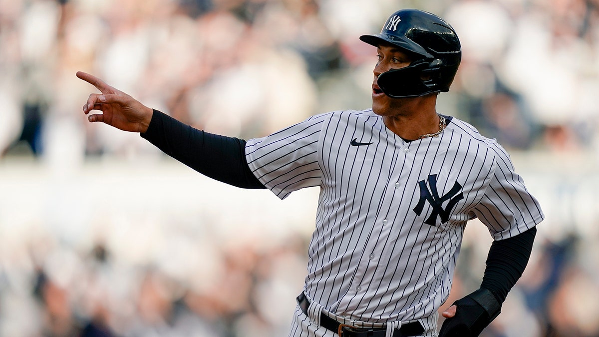 New York Yankees' Aaron Judge reacts as he runs the bases on a two-run home run hit by Giancarlo Stanton off Boston Red Sox starting pitcher Nick Pivetta in the sixth inning of a baseball game, Saturday, April 9, 2022, in New York.