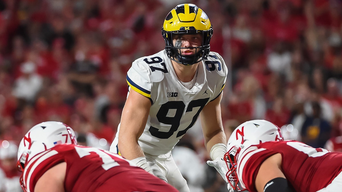 Defensive end Aidan Hutchinson #97 of the Michigan Wolverines looks over the line against the Nebraska Cornhuskers in the first half at Memorial Stadium on Oct. 9, 2021 in Lincoln, Nebraska.