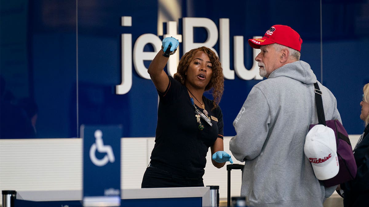 Passengers check in at the terminal at Ronald Reagan Washington National Airport, Tuesday, April 19, 2022, in Arlington, Va. A federal judge's decision to strike down a national mask mandate was met with cheers on some airplanes but also concern about whether it's really time to end the order sparked by the COVID-19 pandemic.