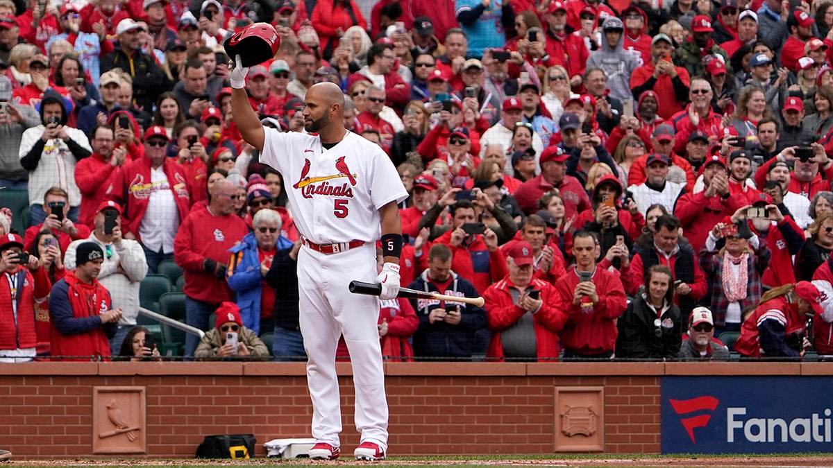 St. Louis Cardinals designated hitter Albert Pujols tips his cap as he steps up to bat during the first inning of a baseball game against the Pittsburgh Pirates Thursday, April 7, 2022, in St. Louis.