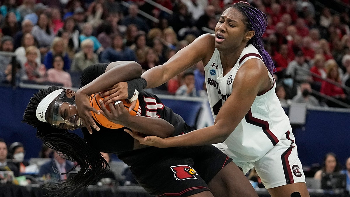South Carolina's Aliyah Boston fouls Louisville's Olivia Cochran during the second half of a college basketball game in the semifinal round of the Women's Final Four NCAA tournament Friday, April 1, 2022, in Minneapolis.