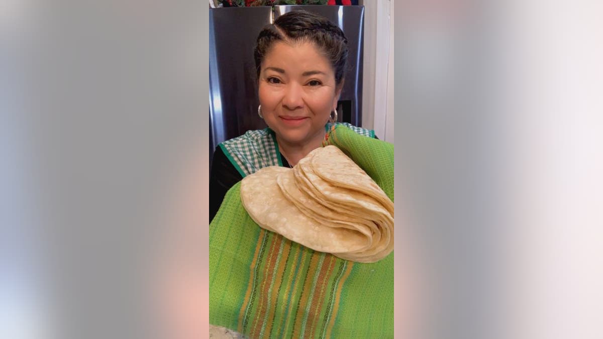 Ana Maria Regalado holds up tortillas
