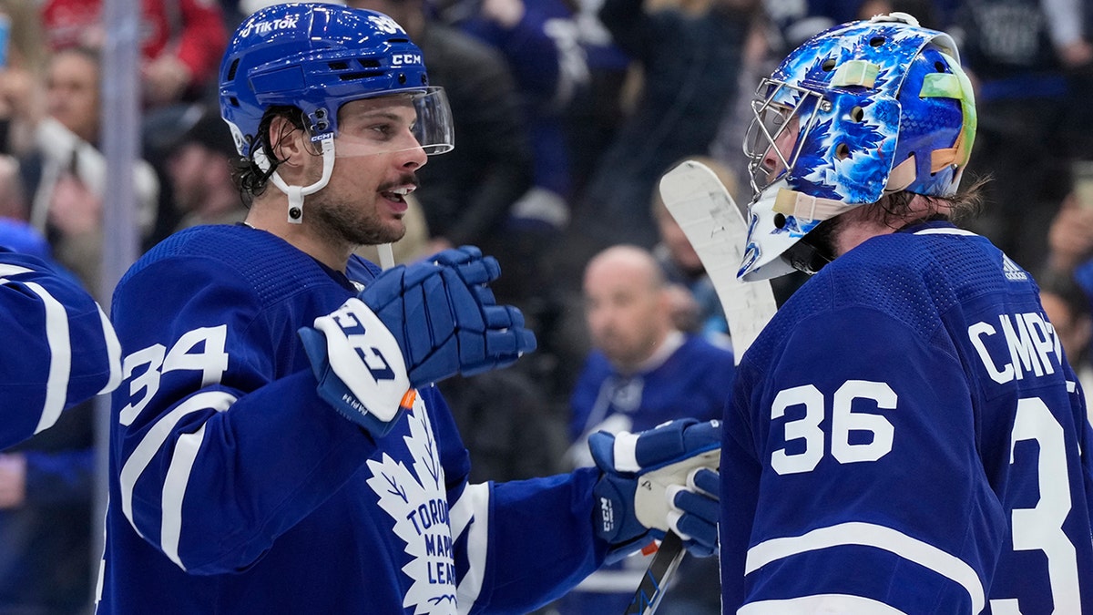 Toronto Maple Leafs center Auston Matthews (34) and goaltender Jack Campbell (36) celebrate the team's 7-3 win over the Washington Capitals in an NHL hockey game Thursday, April 14, 2022, in Toronto.