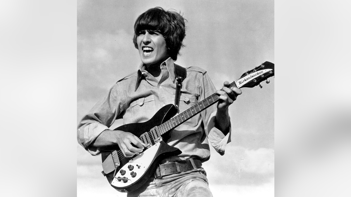 Beatle George Harrison is shown playing the guitar in a scene from the Beatles movie "Help!" on location in the Bahamas in 1965.