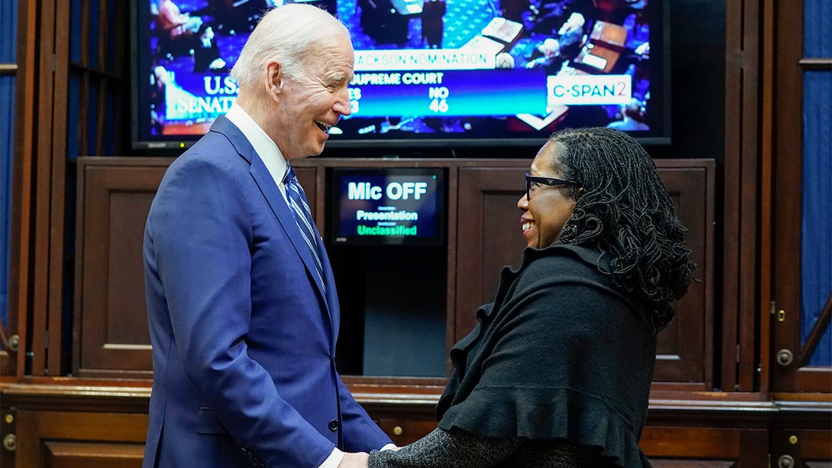 President Biden holds hands with Supreme Court nominee Judge Ketanji Brown Jackson as they watch the Senate vote on her confirmation from the Roosevelt Room of the White House in Washington, Thursday, April 7, 2022. (AP Photo/Susan Walsh)