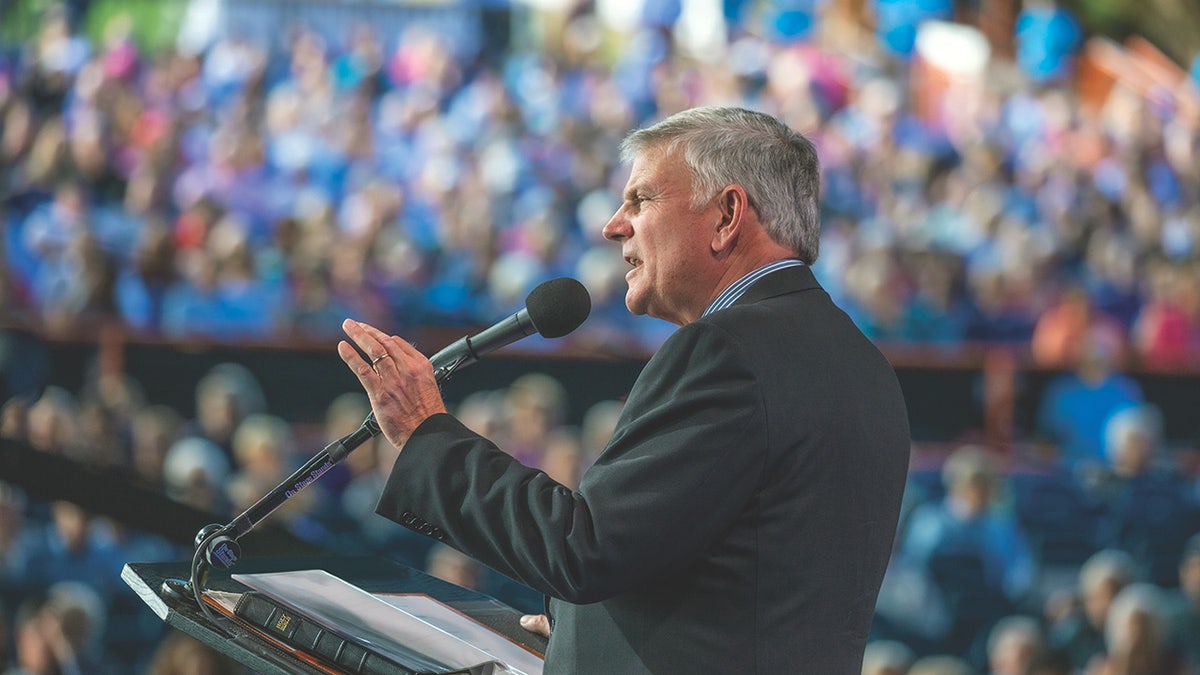 Franklin Graham speaking at lectern into microphone