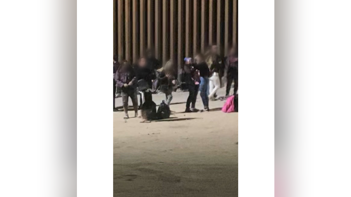 Migrants take selfies at the border. 