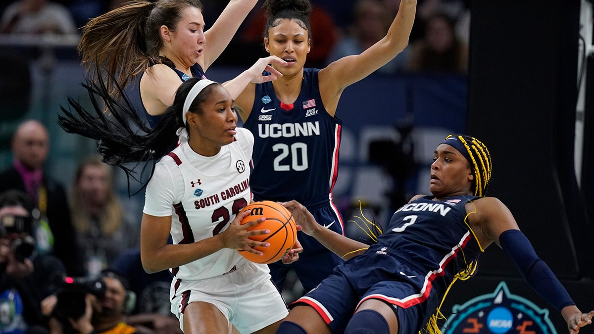 South Carolina's Bree Hall battles with UConn's Aaliyah Edwards during the second half of a college basketball game in the final round of the Women's Final Four NCAA tournament Sunday, April 3, 2022, in Minneapolis.